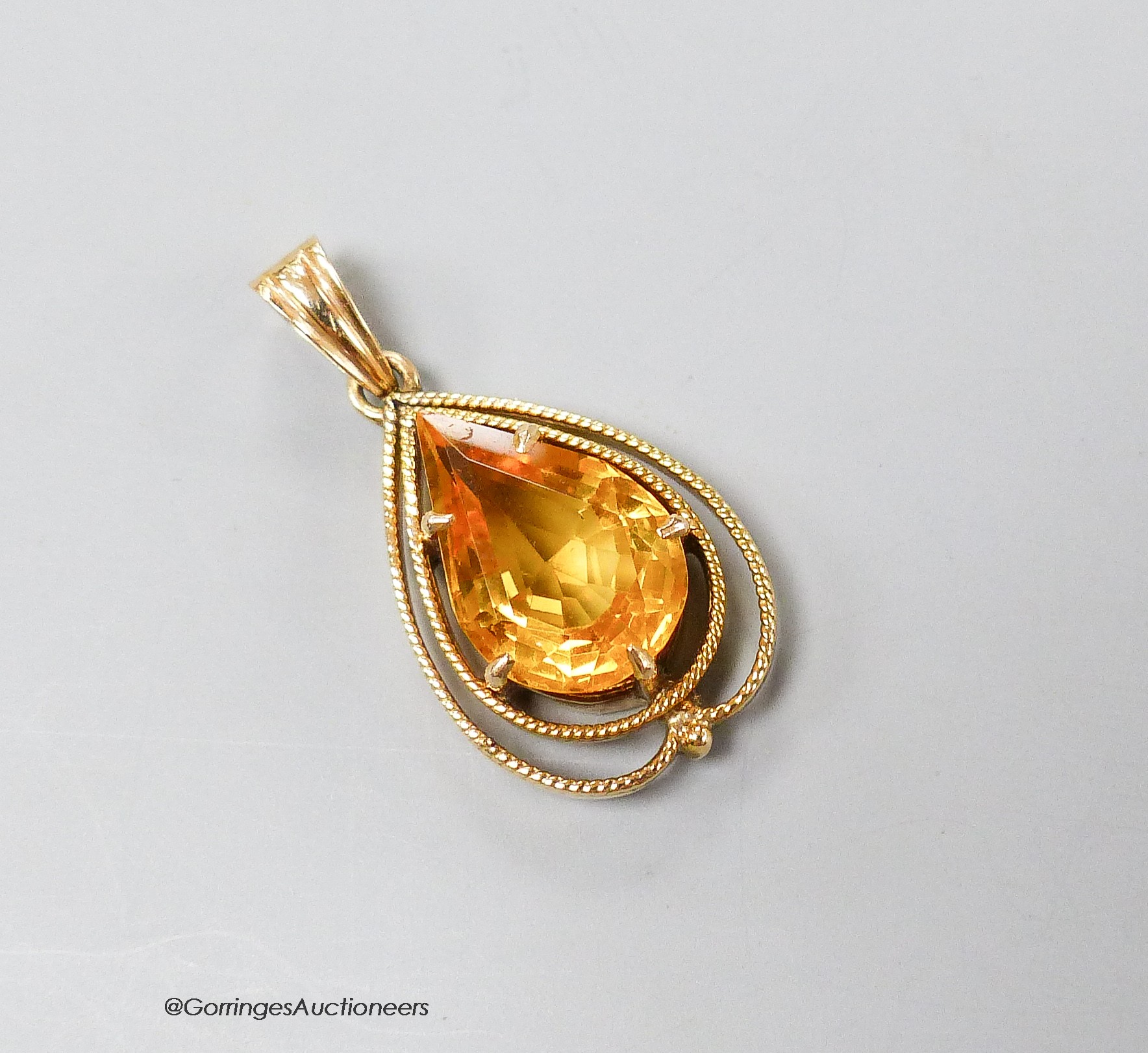 A 14k yellow metal and pear shaped citrine set drop pendant, 29m, gross 3.7 grams.